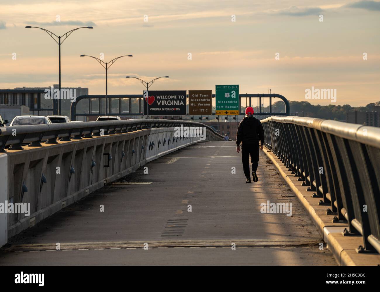 Alexandria, VA - 4 November 2021: Man walking over the Woodrow Wilson bridge trail towards Virginia Stock Photo