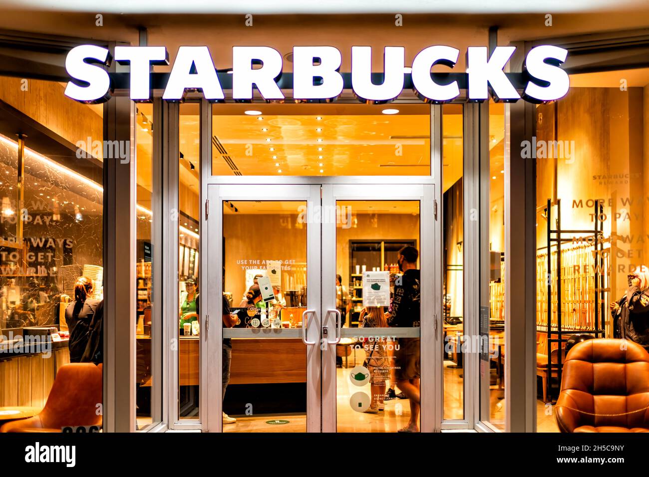 Miami Beach, USA - January 20, 2021: Famous Lincoln road shopping street with sign entrance exterior for Starbucks coffee cafe restaurant store in Flo Stock Photo
