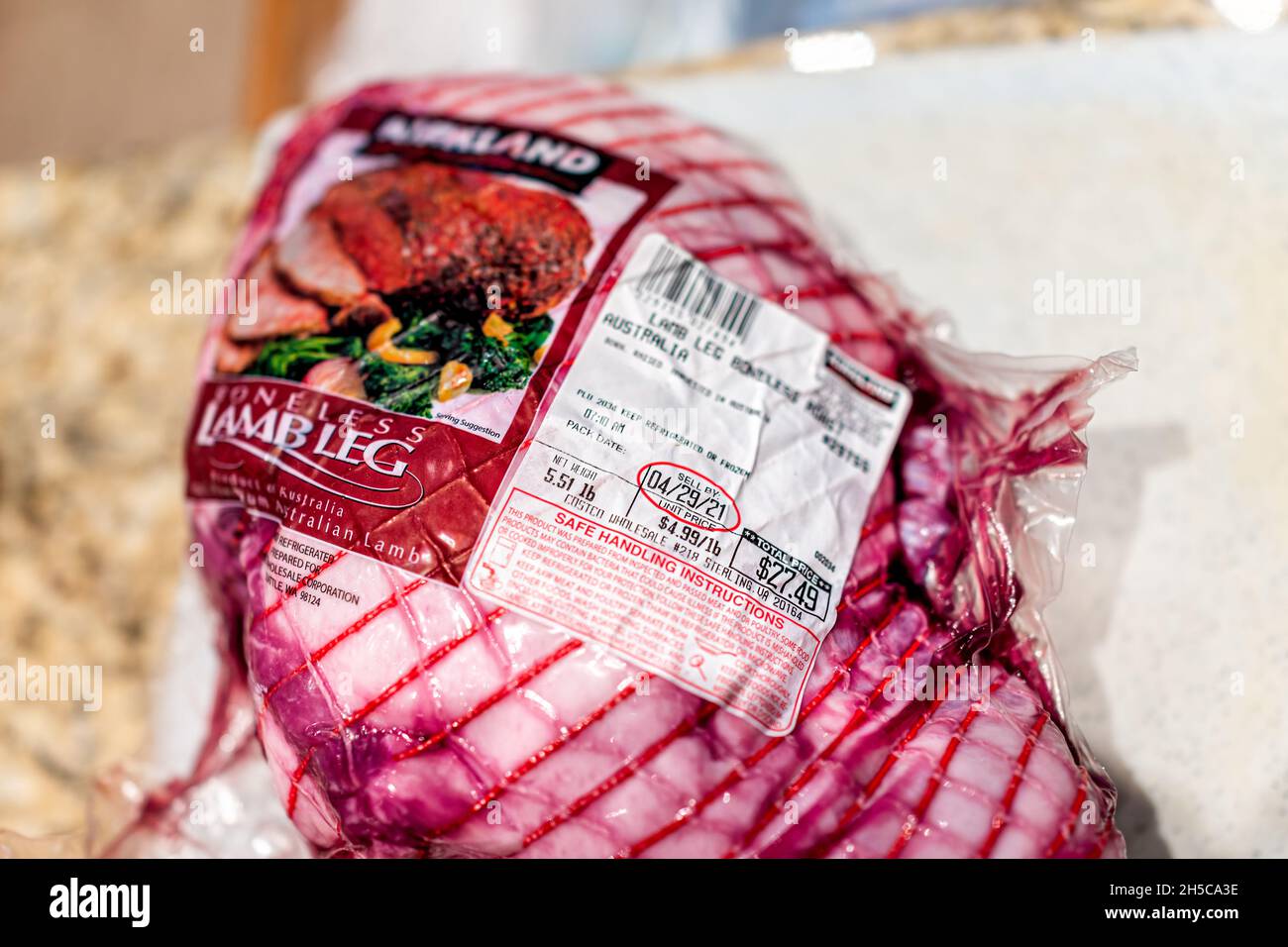 Herndon, USA - March 32, 2021: Red boneless raw lamb meat whole leg by Costco Kirkland Brand from Australia with sign label for price packaged Stock Photo