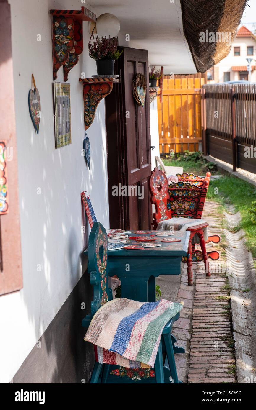 Traditional hungarian motifs painted furniture on display outside a cottage, Mezőkövesd, Hungary Stock Photo