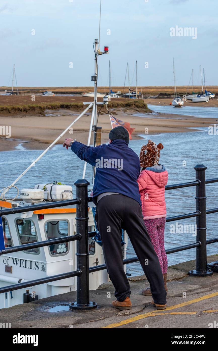 grandad showing his granddaughter sights and scenes at wells next the sea in norfolk, granddad and granddaughter, grandparents, granparenting, Stock Photo