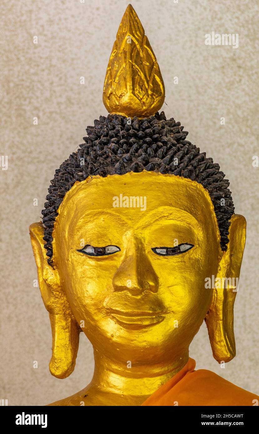 golden head of thailand buddhist deity or god, thai buddha, gold relief, sculpture in gold, golden bust statue depicting thailand buddha god. Stock Photo