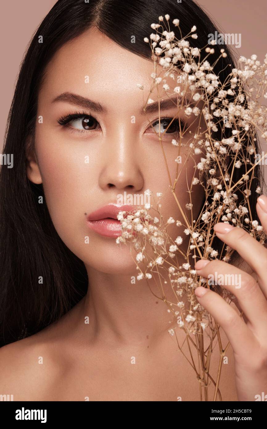 Beautiful delicate woman of oriental type with nude makeup and perfect  skin. Beauty face. Spa Stock Photo - Alamy