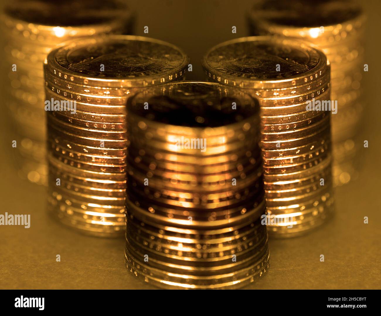 Old gold coins in stacks or piles for money cash representing wealth and riches collection golden Stock Photo