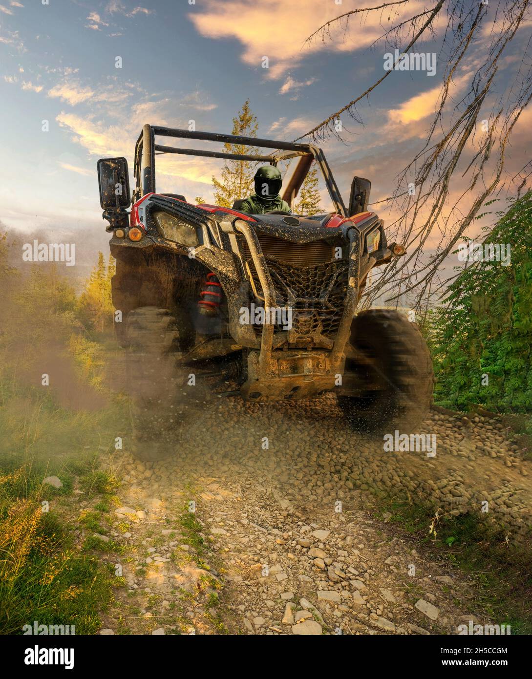 4x4 off-road corridors designed metal utility terrain vehicle car or truck drive by a driver with helmet during passing mud part of special section of Stock Photo