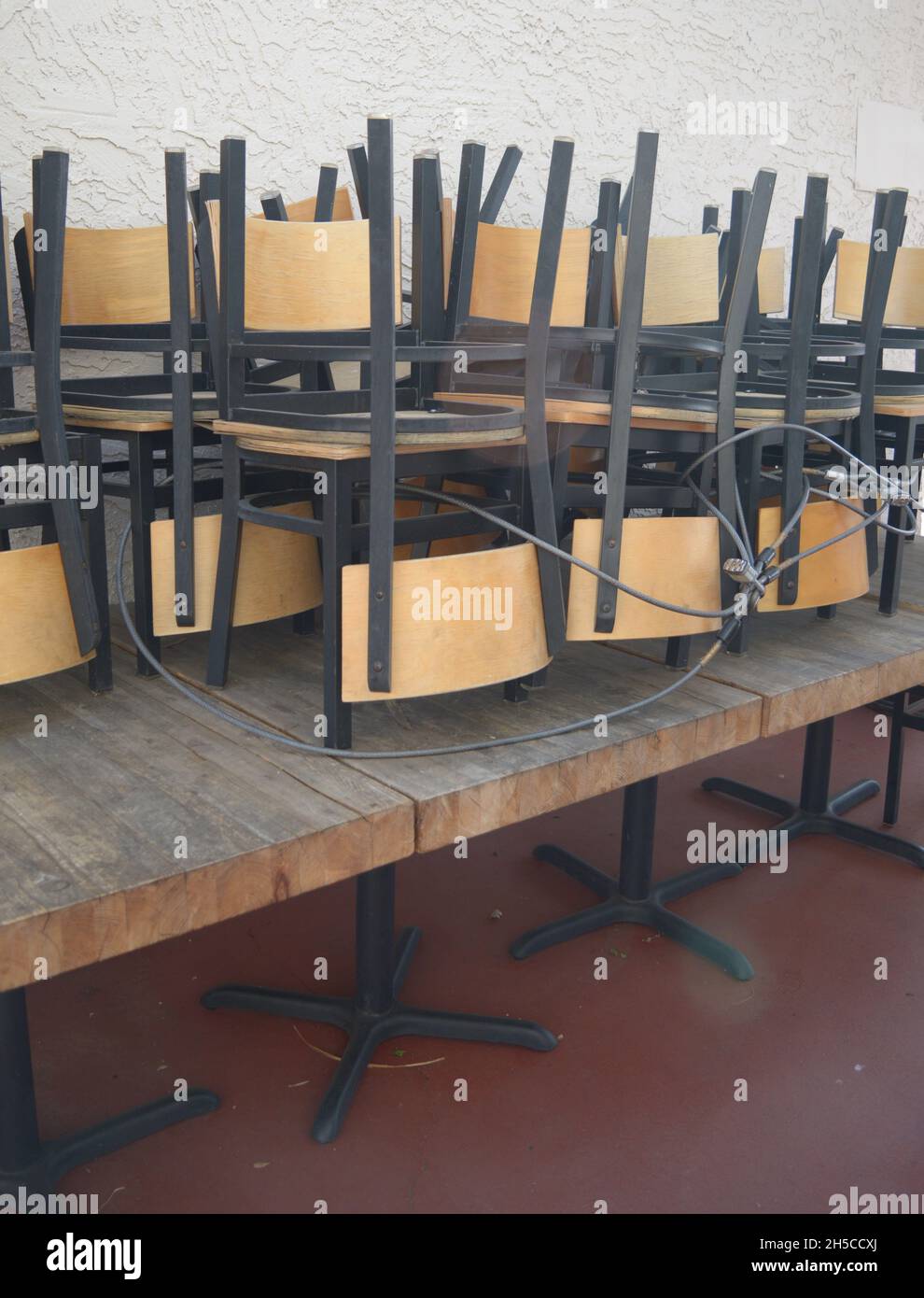 Vertical shot of a restaurant chairs stored upside down and locked up