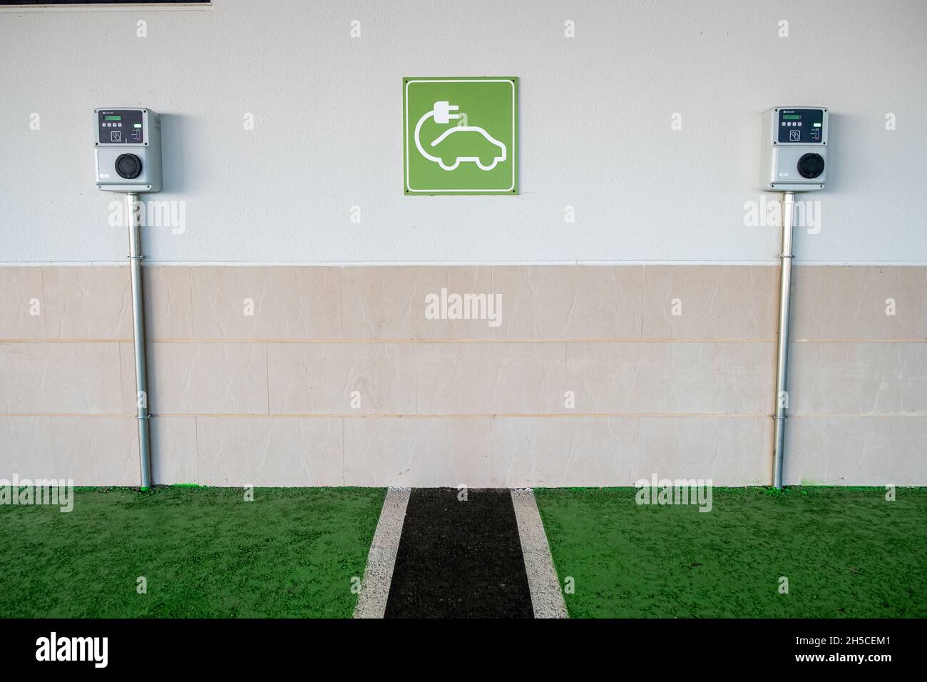 Electric charging point for vehicles cars bikes free no charge operated in shopping mall retail park in car parking space Stock Photo