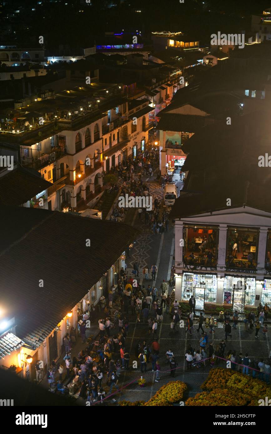 Photograph of a crowded town square, taken at night from a building. Stock Photo