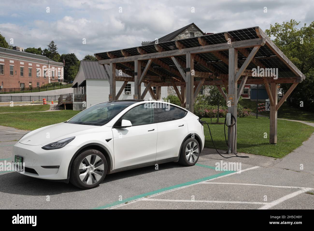 Tesla car at a public electric vehicle charging station in Middlebury