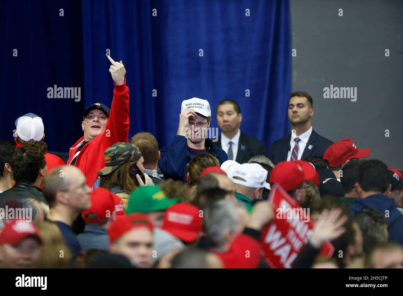 11052018 - Fort Wayne, Indiana, USA: Trump supporters flip off CNN reporter Jim Acosta before United States President Donald J. Trump campaigns for Indiana congressional candidates, including Mike Braun, who is running for senate, during a Make America Great Again! rally at the Allen County War Memorial Coliseum in Fort Wayne, Indiana. Stock Photo