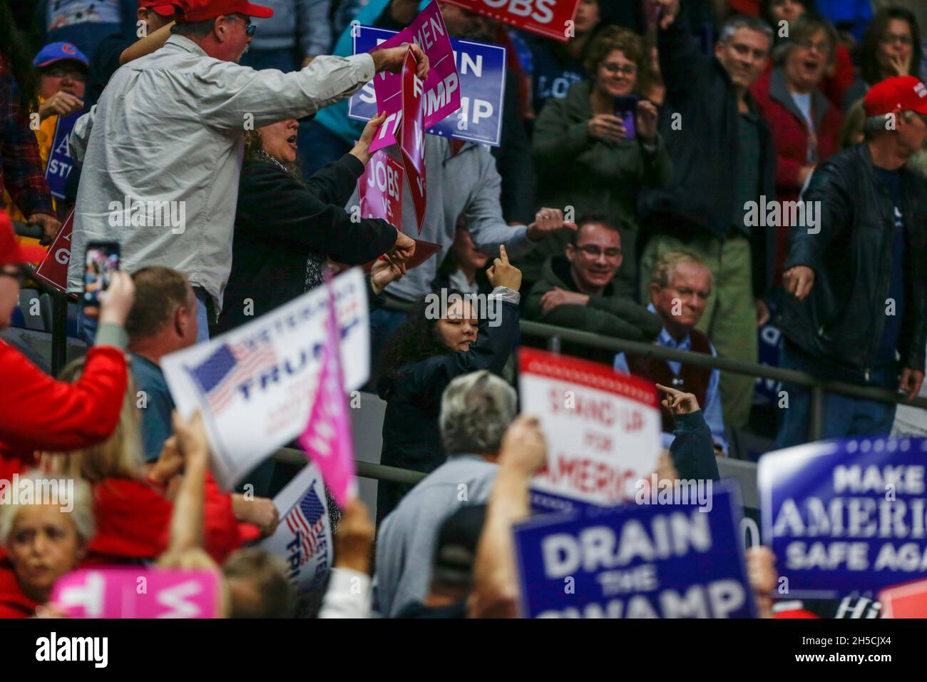 11052018 - Fort Wayne, Indiana, USA: A protester is escorted away as United States President Donald J. Trump campaigns for Indiana congressional candidates, including Mike Braun, who is running for senate, during a Make America Great Again! rally at the Allen County War Memorial Coliseum in Fort Wayne, Indiana. Stock Photo