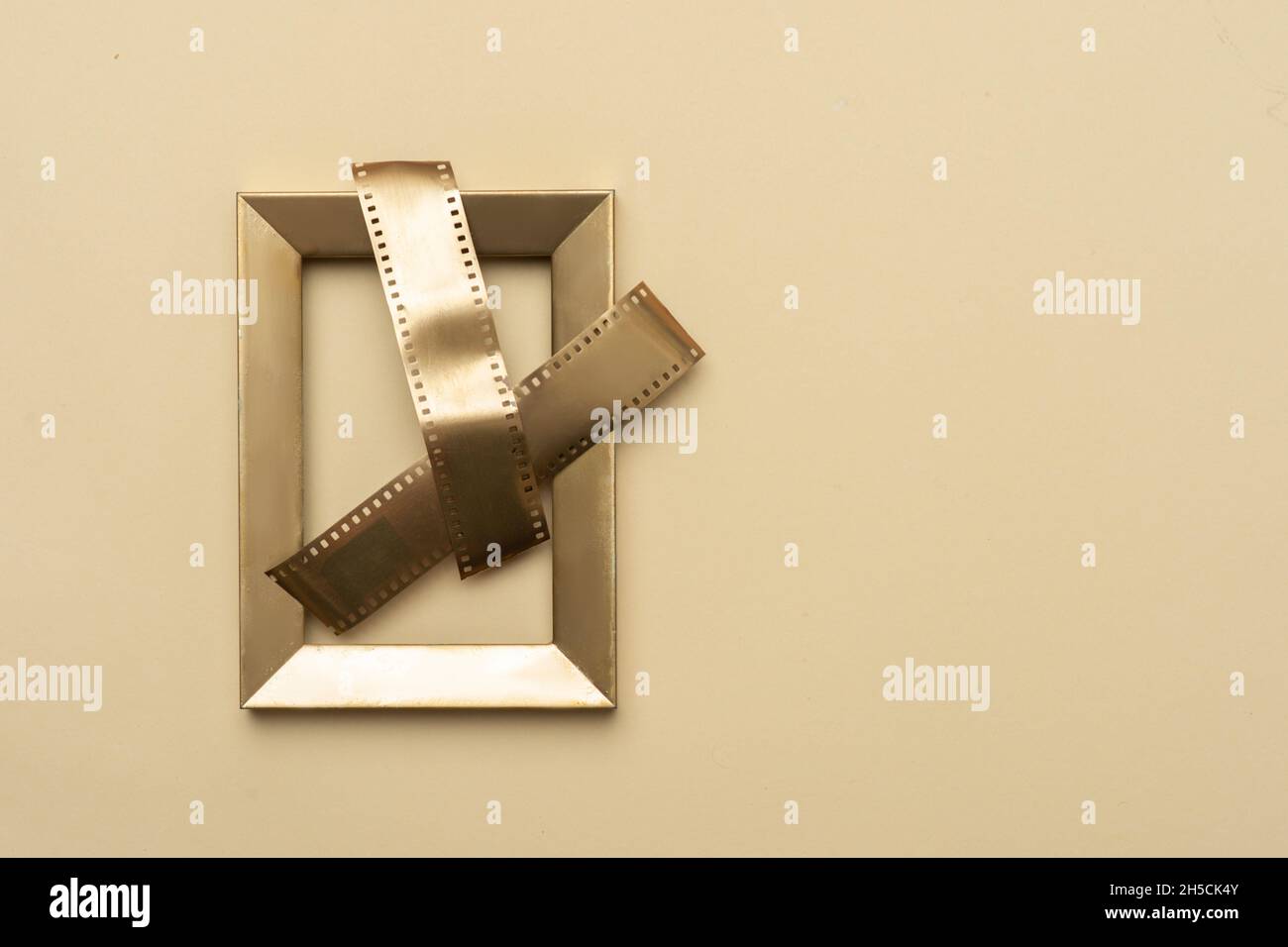 Gold film strips on gold frame on beige background. Horizontal media theme poster, greeting cards, headers, website and app Stock Photo