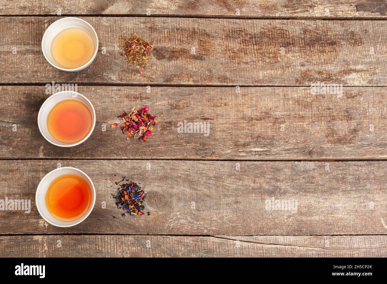 Collection of different teas in cups with tea leaves Stock Photo Alamy