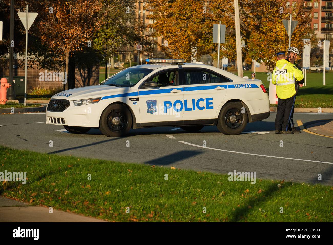 Halifax police car parked across a street to block traffic while officer attends to business on side Stock Photo