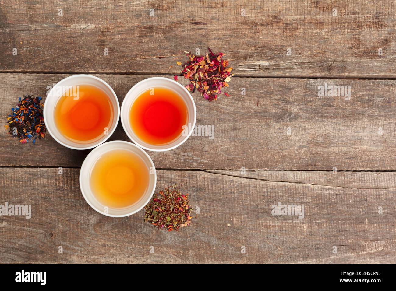 Collection of different teas in cups with tea leaves Stock Photo Alamy
