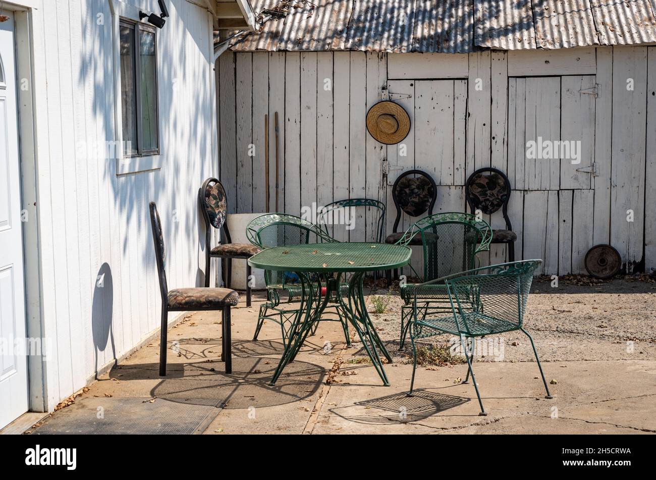 Photo of an outdoor patio area with hanging hat and outdoor furniture at a farm in the Central Valley of California. Stock Photo