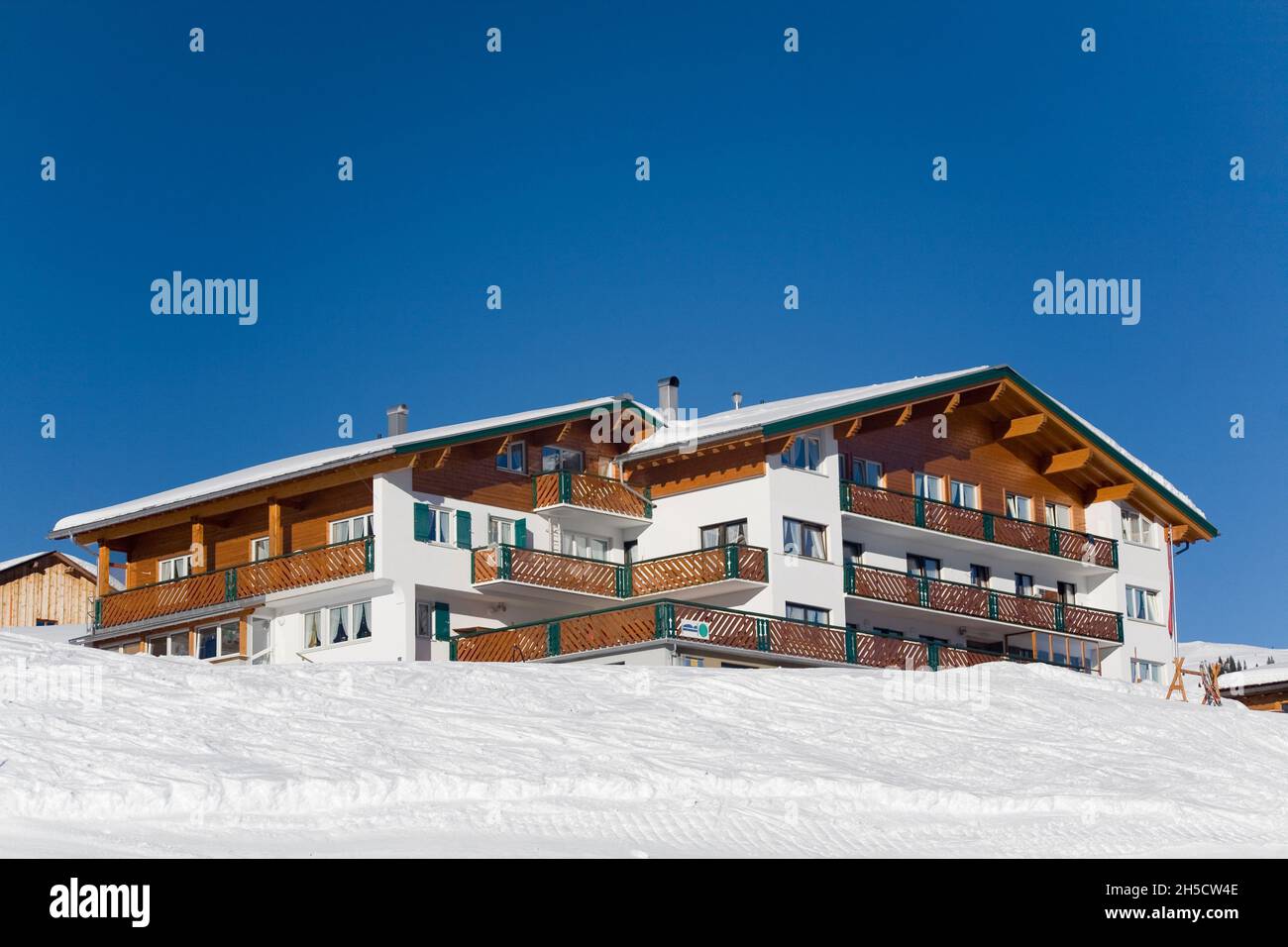 snowy hotel in the alps in sunshine , Germany, Bavaria Stock Photo