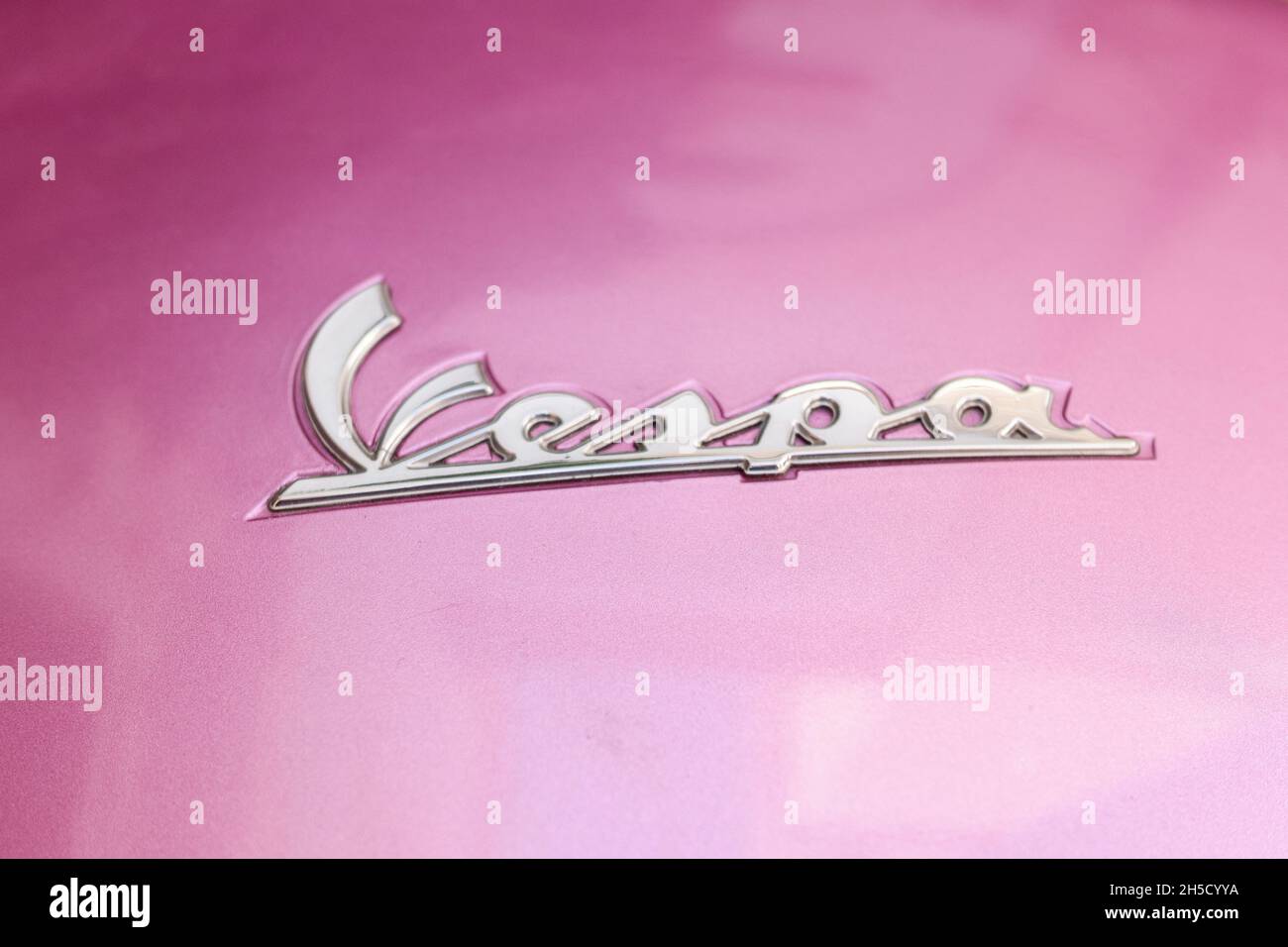 Milano, Italy. October 6, 2021: Vespa logo, motorcycle brand, on a pink background. Stock Photo