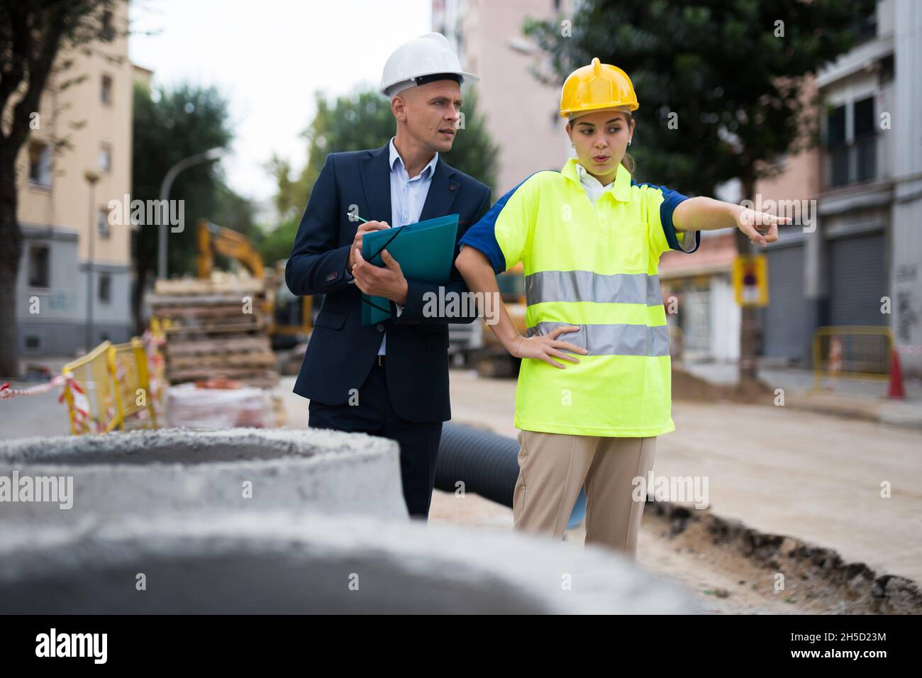 Civil engineers checking work process in construction site Stock Photo ...