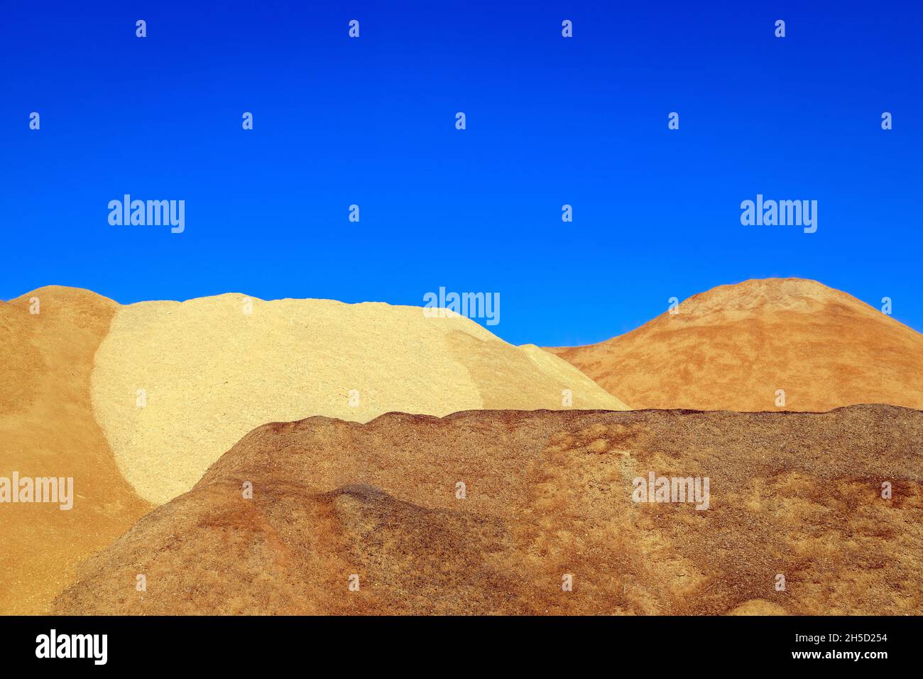 Piles of wood chips to be made into wood pellet fuel a byproduct of the lumber industry and a renewable resource. Stock Photo