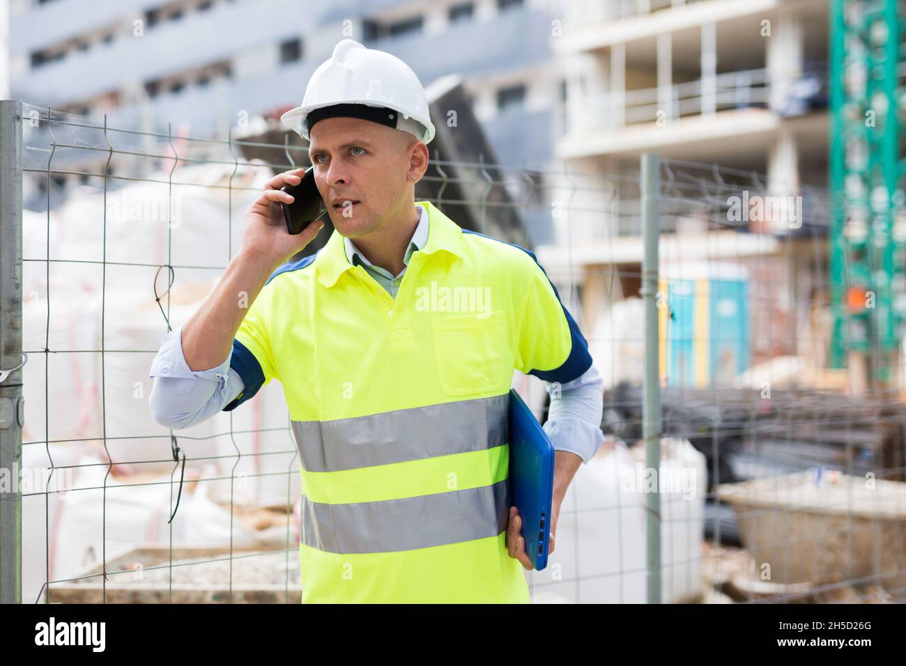 Young engineer is talking on a mobile phone Stock Photo