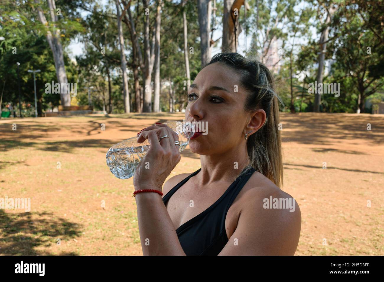 42 year old Brazilian, ripped, drinking water under a shade in a public square Stock Photo Alamy