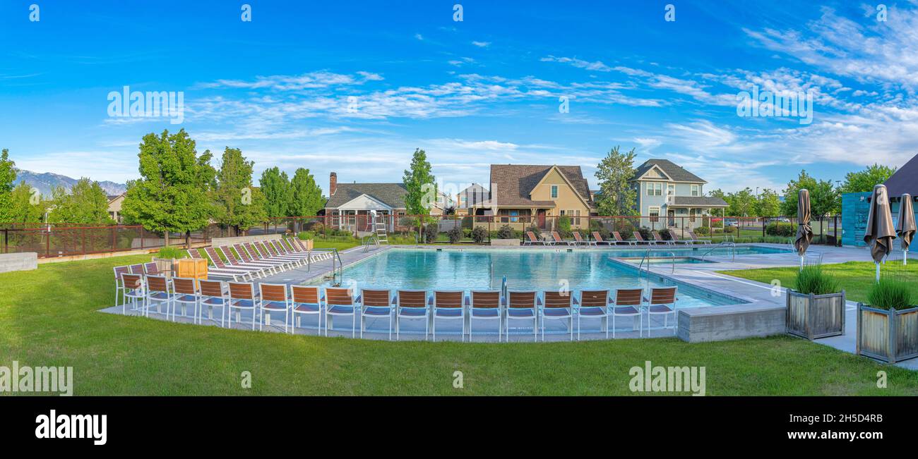 Large community pool at Daybreak, Utah with lounge chairs and closed