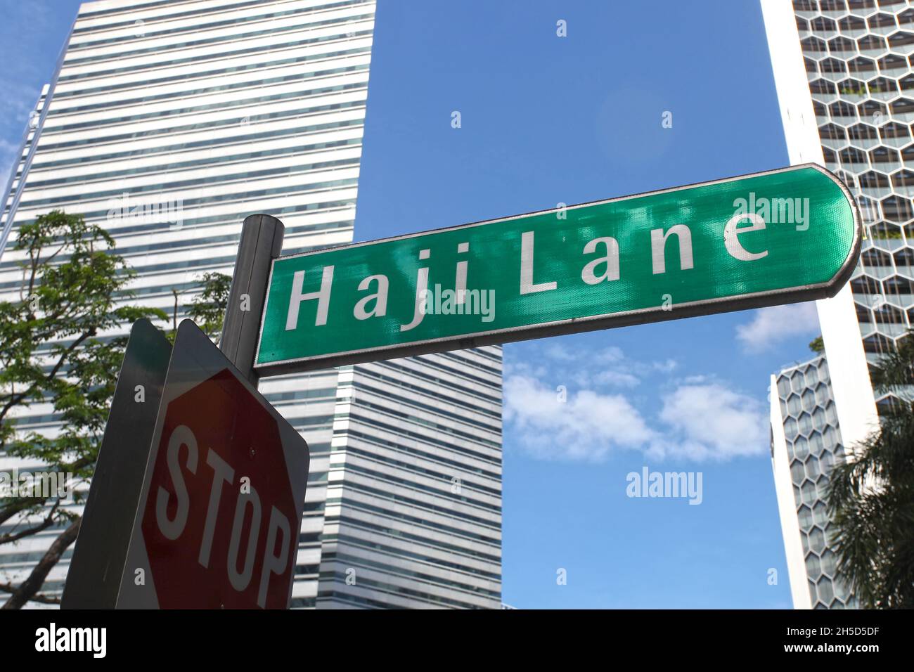 A green street name sign for Haji Lane in the Kampong Glam neighbourhood of Singapore. Stock Photo