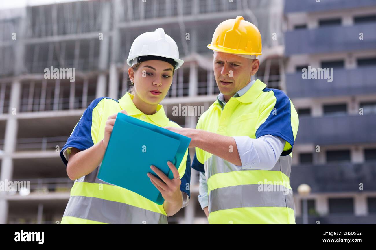 Two qualified engineers are discussing a construction plan Stock Photo