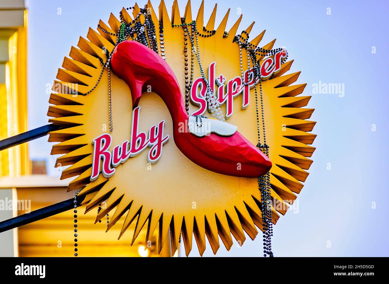 Mardi Gras beads hang from the Ruby Slipper Cafe sign, Nov. 6, 2021, in Mobile, Alabama. Stock Photo