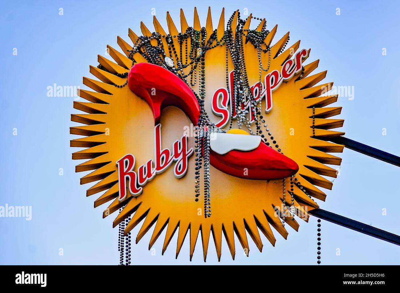 Mardi Gras beads hang from the Ruby Slipper Cafe sign, Nov. 6, 2021, in Mobile, Alabama. Stock Photo
