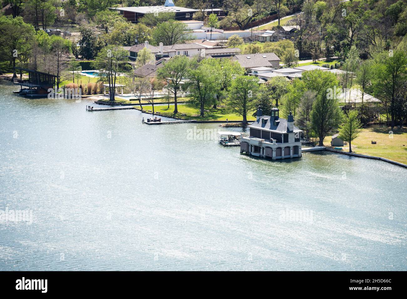 Colorado River in Austin Texas with Big Houses on the Waterfront and Boat Houses Stock Photo