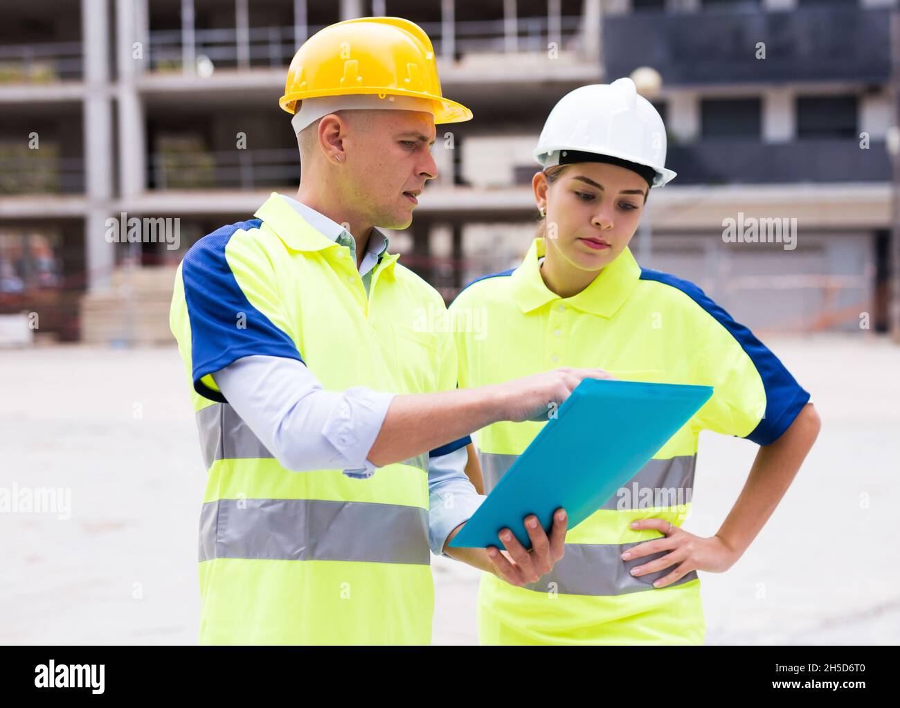 Two qualified engineers are discussing a construction plan Stock Photo
