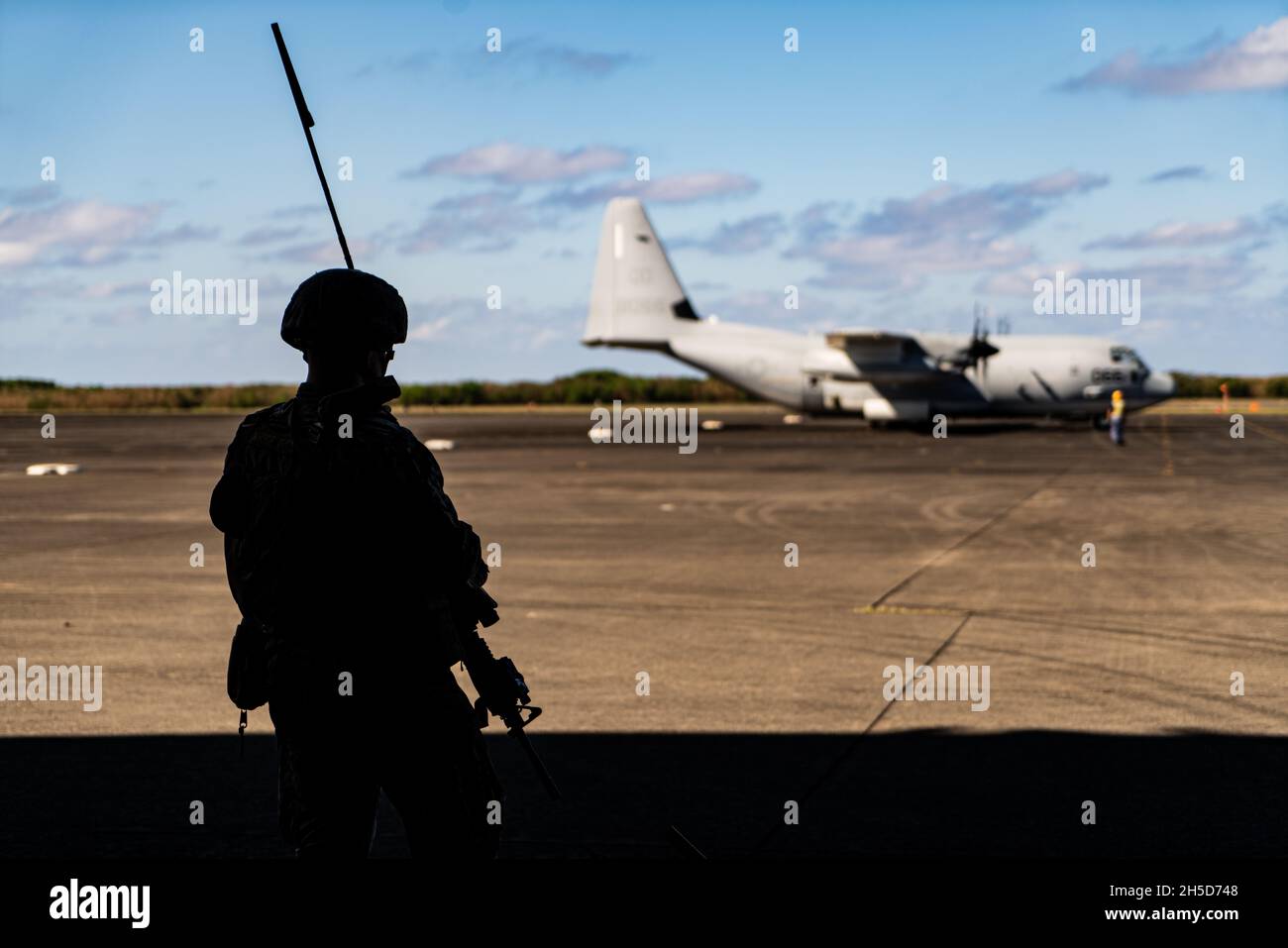 A U.S. Marine with 3d Battalion, 12th Marines, 3d Marine Division, establishes communications during a High Mobility Artillery Rocket System rapid aerial insertion mission at Iwo To, Japan, Nov. 1, 2021. Upon landing, Marines swiftly moved to a concealed position and prepared to engage simulated targets. The training demonstrated 3d Marine Division’s ability to quickly deploy long range precision fires capabilities to key maritime terrain across the Indo-Pacific region. (U.S. Marine Corps photo by Lance Cpl. Ujian Gosun) Stock Photo