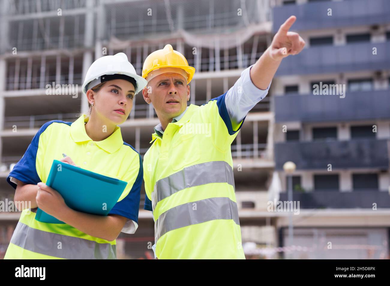 Two qualified engineers are discussing a construction plan Stock Photo