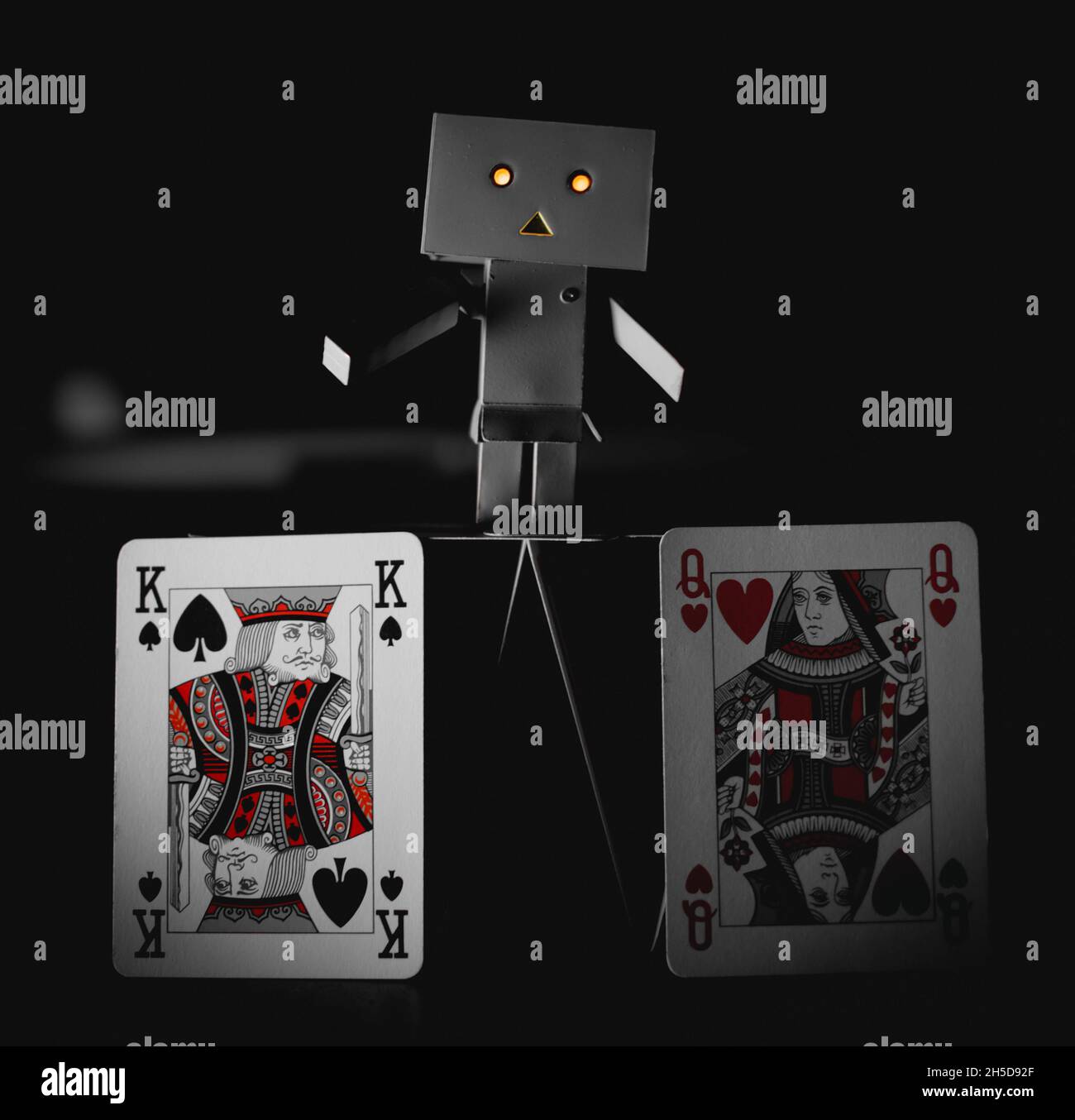 a lovely danbo robot playing with cards Stock Photo