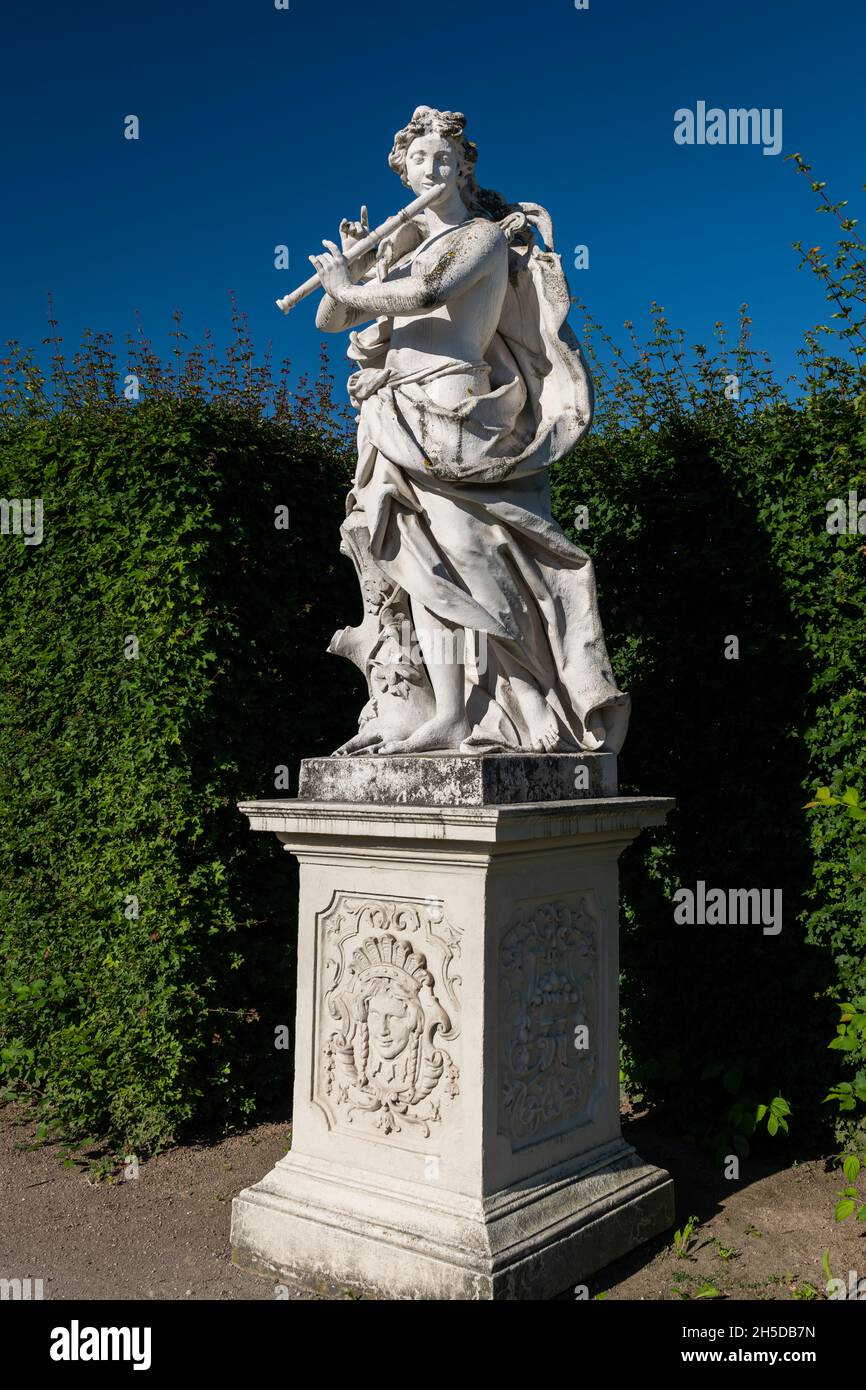 Statue of a musician in Belvedere garden (Vienna, Austria) on a sunny day in summer, blue sky Stock Photo