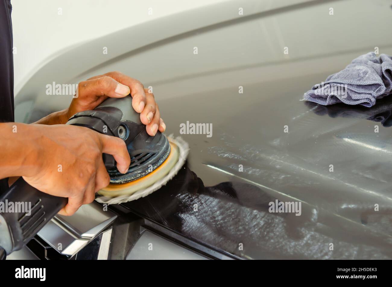 Car detailing Man hands holding the work tool polish the car.Buffing