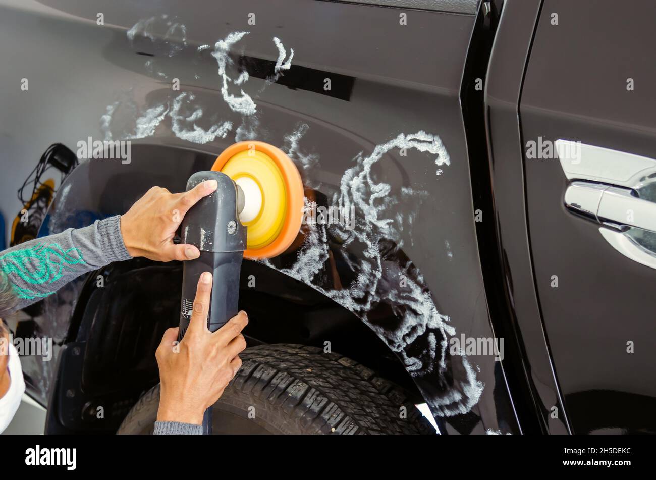 Car detailing Man hands holding the work tool polish the car.Buffing
