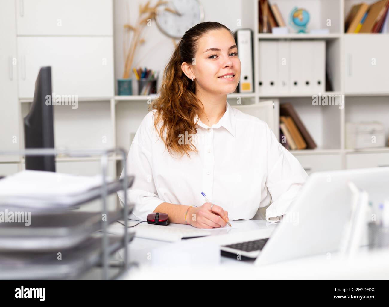 Portrait of young female office worker Stock Photo - Alamy
