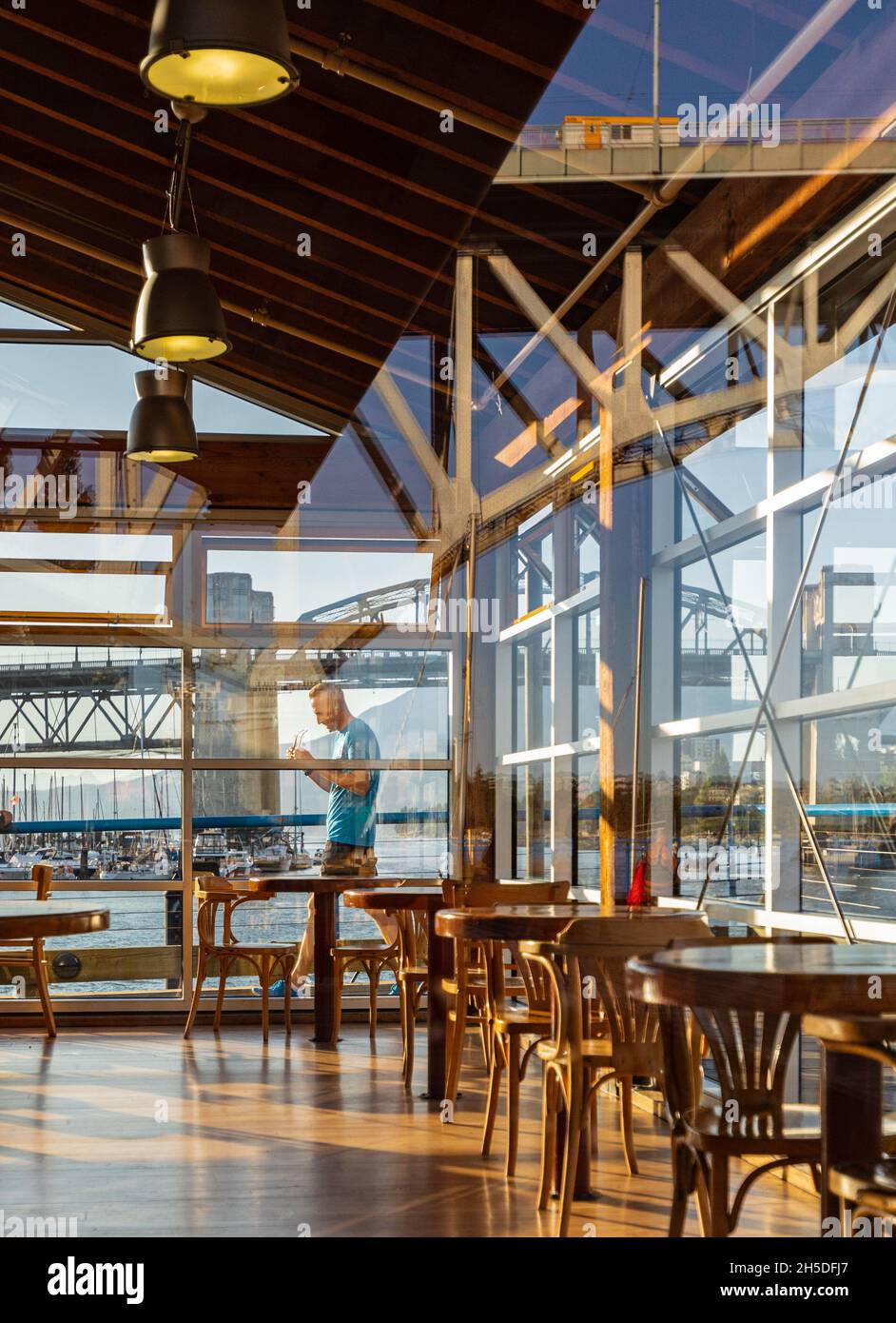 Restaurant view through a window. Classic style decoration restaurant table set. Wooden window with a restaurant view through the glass. Street view, Stock Photo