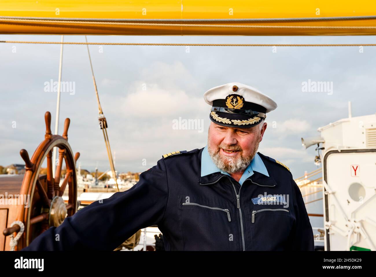Kiel, Germany. 08th Nov, 2021. The commander of the sail training ship 'Gorch Fock', Captain Nils Brandt, stands on deck. On the fringes of a press event, it became known that the first training voyage of the retreaded sail training ship will be postponed at short notice. A navy spokesman said the reason was germs in the drinking water system. Credit: Frank Molter/dpa/Alamy Live News Stock Photo