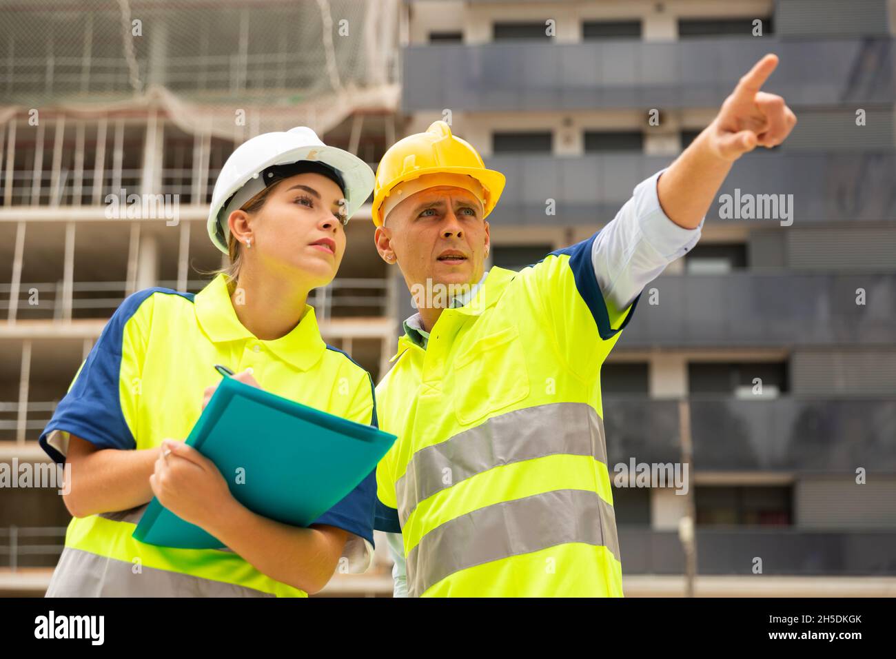 Two qualified engineers are discussing a construction plan Stock Photo