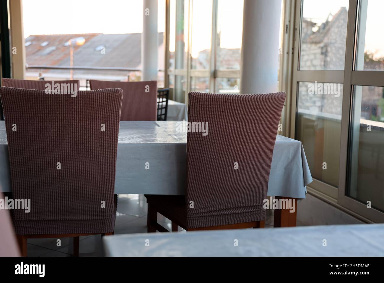 Table and chairs by the window in a restaurant Stock Photo Alamy