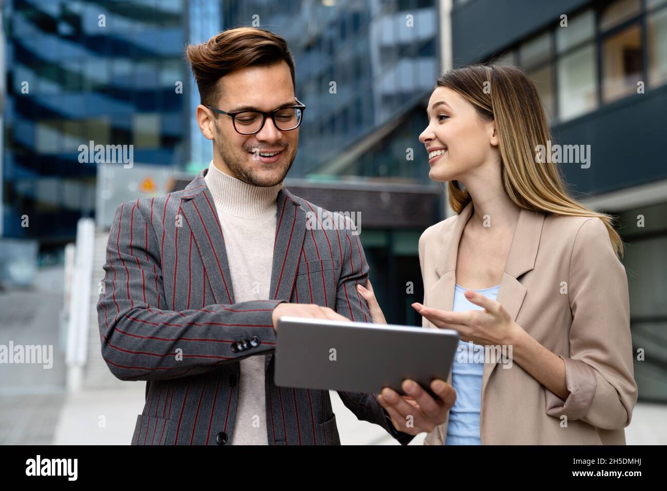 Portrait of successful business people working, talking together in urban background. Stock Photo
