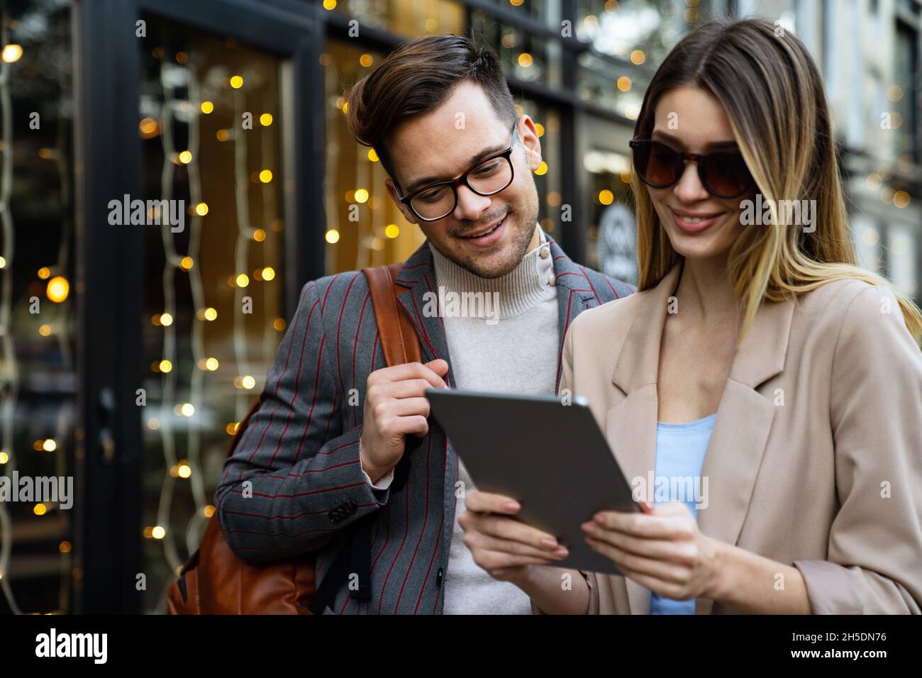 Portrait of successful business people working, talking together in urban background. Stock Photo