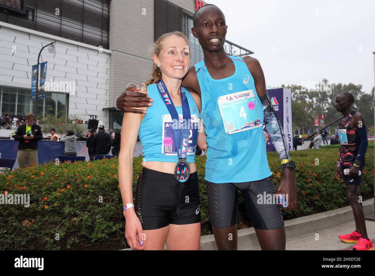 Natasha Cockram (GBR), left, and John Korir (KEN) pose after winning