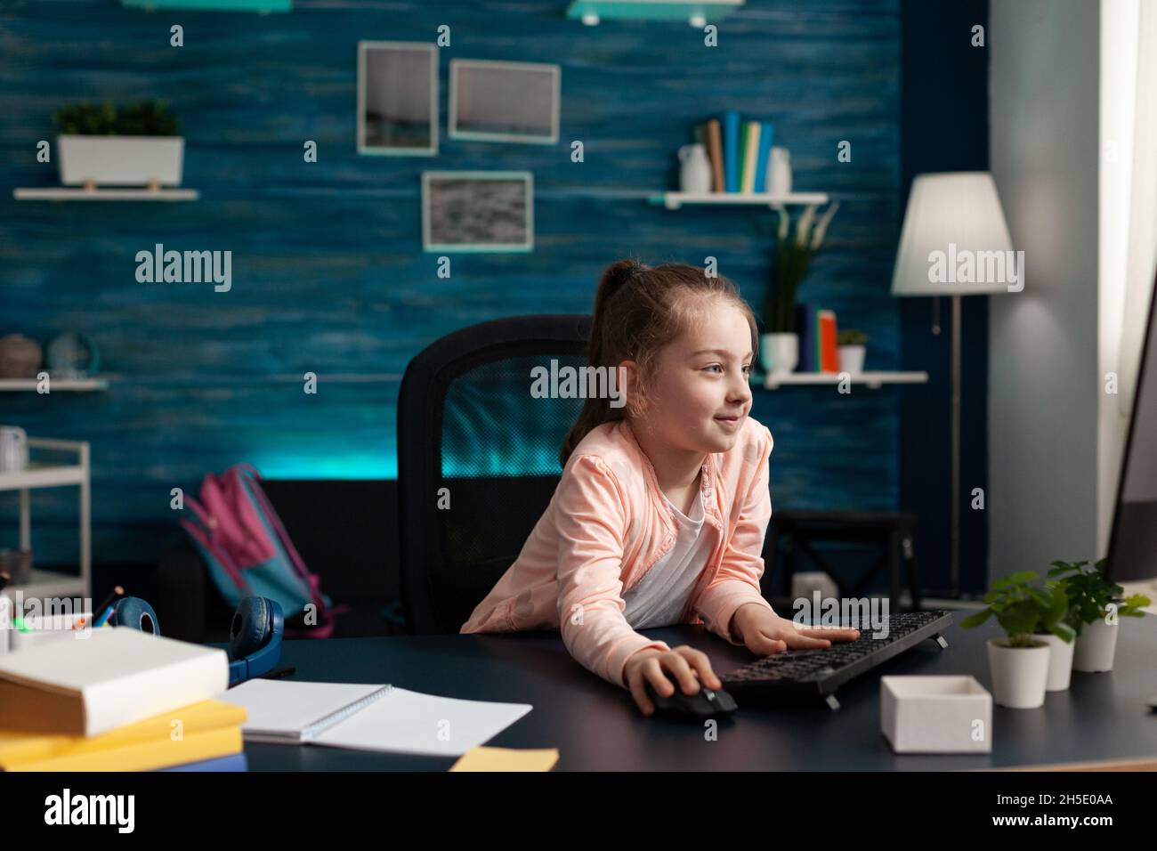 Elearning Room Little schoolchild doing literature homework using elearning classroom ...