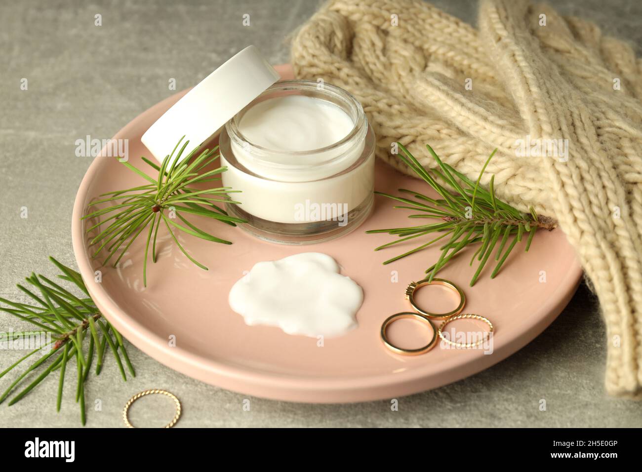 Concept of winter cosmetic products on gray textured table Stock Photo