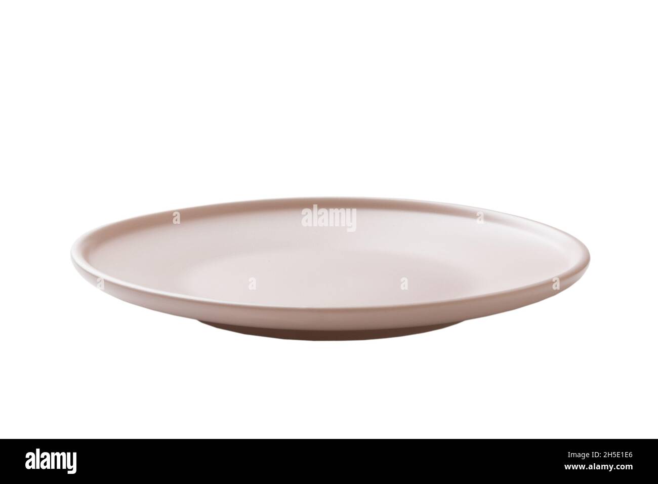 Pink ceramic round plate isolated over white background. perspective ...